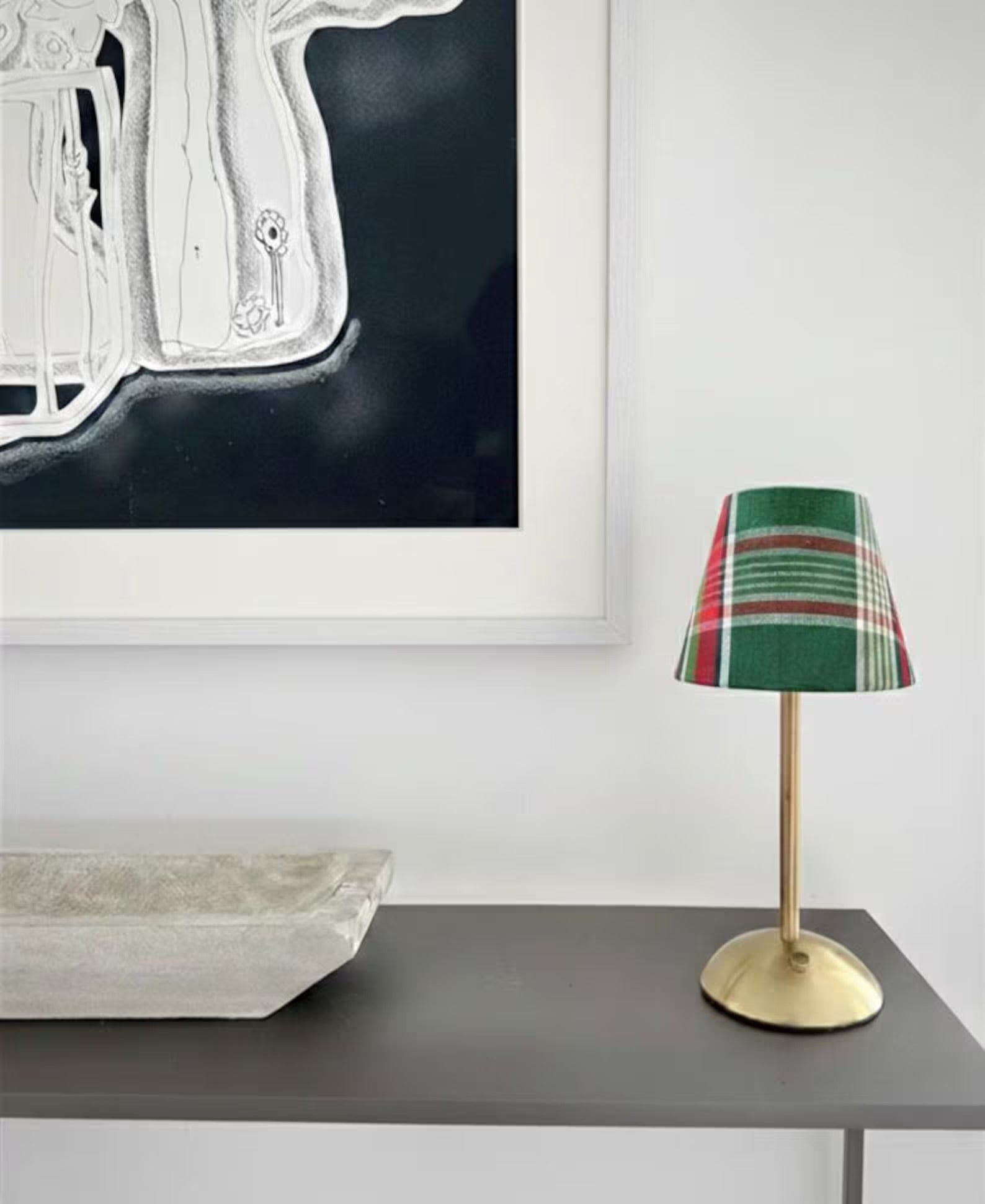 Archival Studio styling of The Aspen plaid shade for a cordless lamp positioned beside minimalist art and architectural decor.