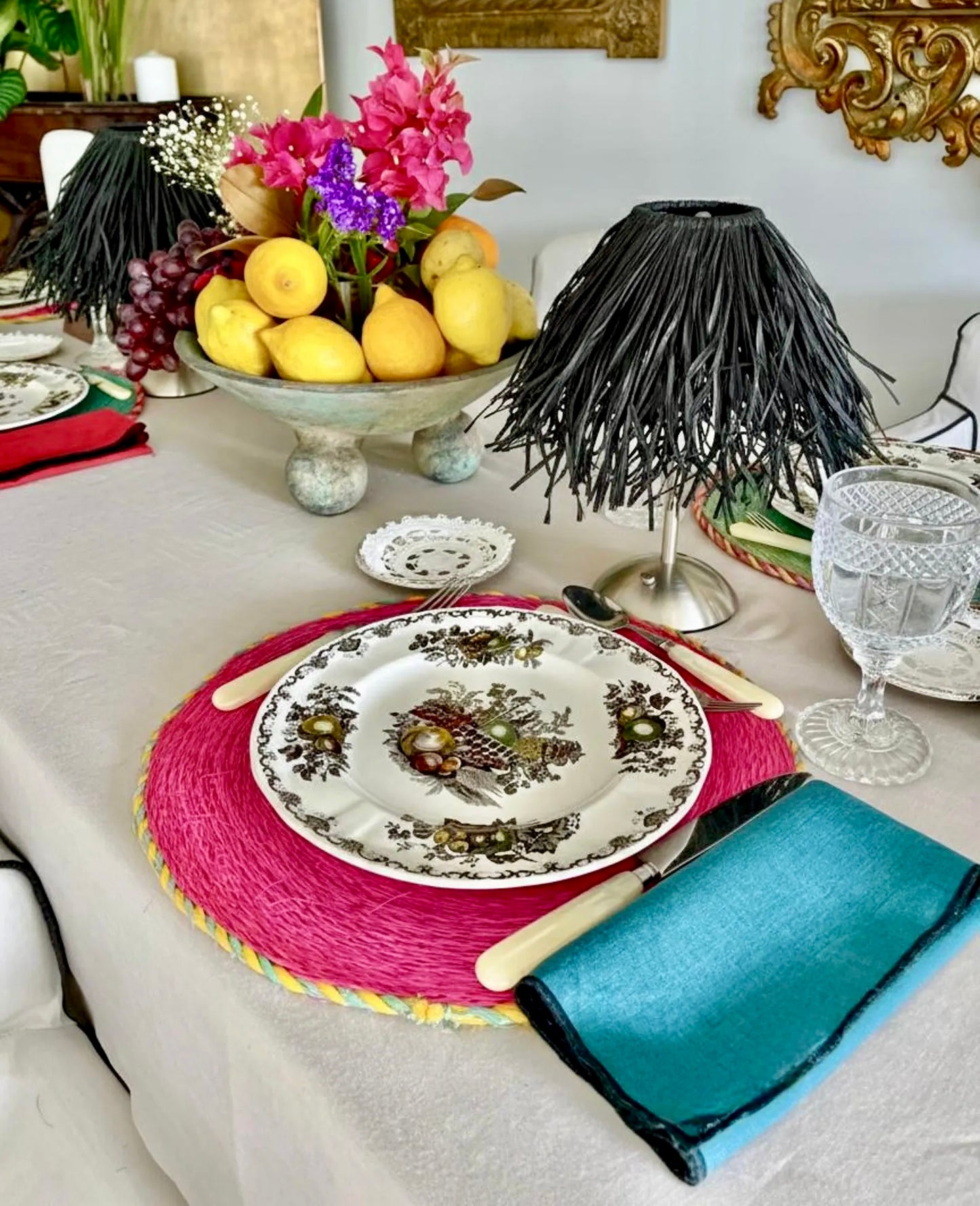 Pair of black handwoven raffia lamp shades on cordless lamps styled on an elegant dining tablescape for scale.