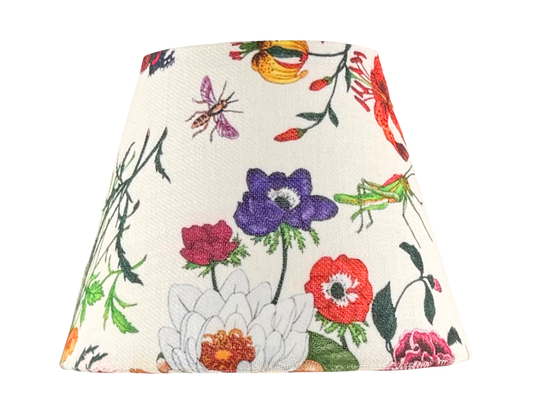 The Botánica floral lamp shade for cordless lamps featuring a botanical print with insects on a white background.