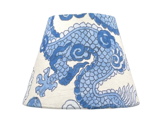 Close-up of the Magic Mountain Lamp Shade – A Schumacher chinoiserie-inspired lamp shade featuring intricate blue dragons and foo dogs on a natural linen background.