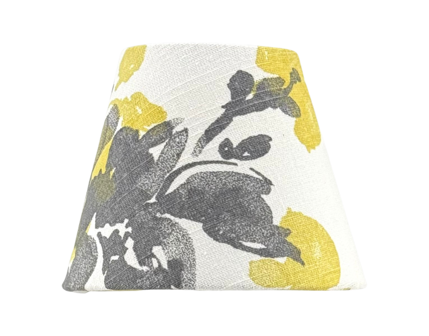 A handmade linen lamp shade with a abstract floral print in mustard yellow and charcoal colors, designed for use with cordless lamps.